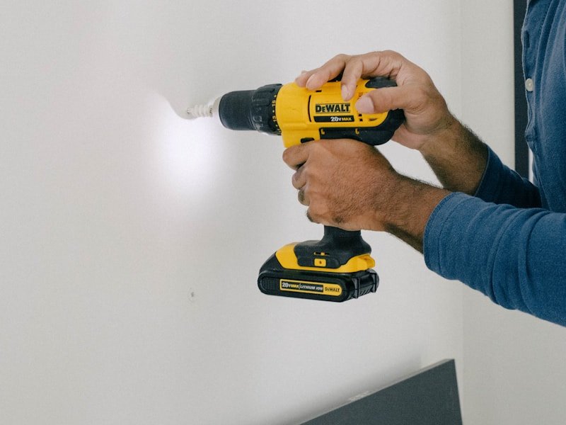 Drilling pilot holes in drywall for a flat-screen TV mount.